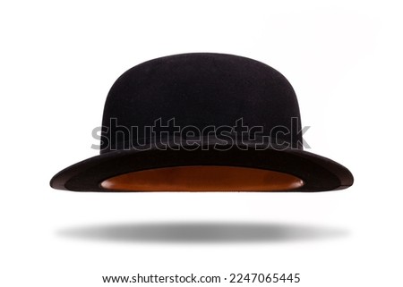 Black bowler hat floating with shadow isolated on white background