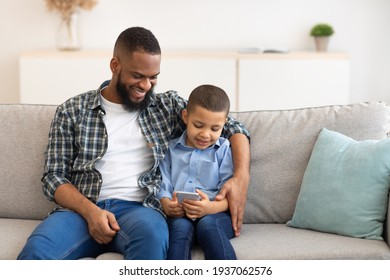 Black Boy And Dad Using Phone Playing Games Online Indoor