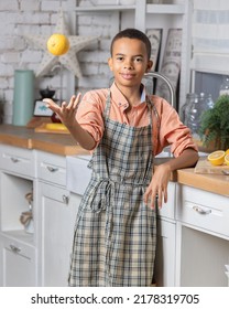 Black Boy Kid Cooking Fresh Lemon On Kitchen At Home. African Child Preparing On Table.