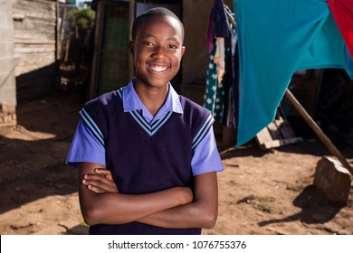 Black Boy Standing In His School Clothes With His Arms Crossed.