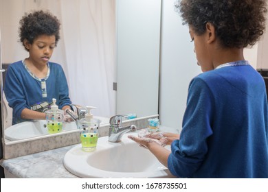 Black Boy Washing His Hands With Soap In The Bathroom At Home To Avoid Infections Coronavirus