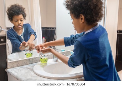 Black Boy Washing His Hands With Soap In The Bathroom At Home To Avoid Infections Coronavirus