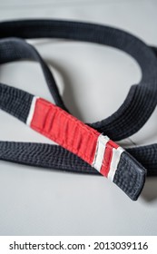 Black Brazilian Jiu Jitsu Bjj Belt On The Floor On The Tatami In Gym