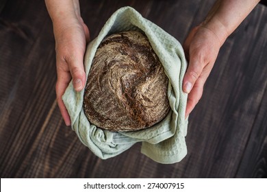black bread in hands 