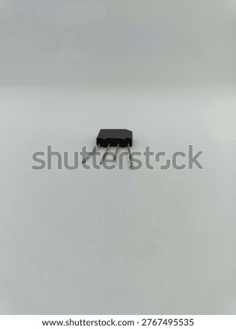 A black bridge rectifier diode component or comb diode isolated on a white background for electronic circuit power supply.