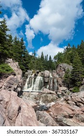 Black Brook water fall in Cape Breton's Cabot Trail with trees and sky