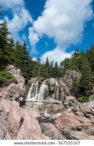 Black Brook water fall in Cape Breton's Cabot Trail with trees and sky
