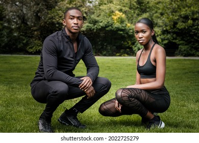 Black Brother And Sister Twins Posing Outdoor In Stylish Sportswear. They Are In A Park In A Cloudy Spring Day.