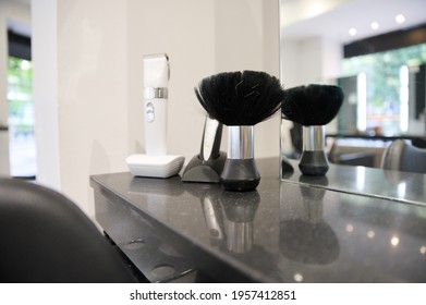 Black Brush And Two Hair Clippers In Unisex Hair Salon