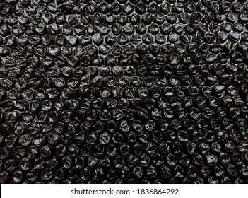 black bubble plastic wrap surface. plastic with air balls on the surface used to pack glassware or electronics or sensitive items - Powered by Shutterstock