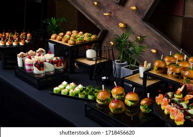 Black buffet table with beautiful decorated dishes. Breakfast at hotel. Catering. Decoration for a Banquet