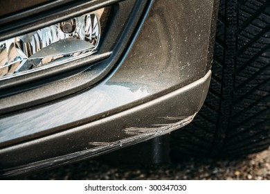 Black Bumper Car Scratched With Deep Damage To Paint.