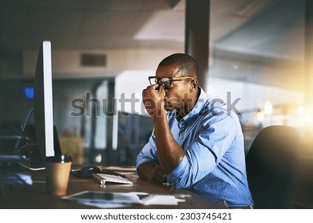 Black business man, stress and fatigue in night, office and headache by computer for project deadline. African businessman, burnout or anxiety in workplace by pc, web design startup and mental health