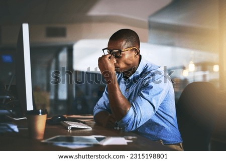 Black business man, stress and headache in night, office and fatigue by computer for project deadline. African businessman, burnout or anxiety in workplace by pc, web design startup and mental health