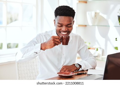 Black Business Man With Tea, Cafe Restaurant For Online Work And Happy Startup Manager In Chicago. Working At Company Kitchen Table With Laptop, Coffee Break From Tech Office And Employee Relaxing