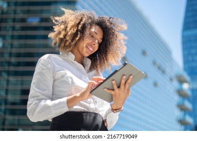 Black Business Woman Using Her Digital Tablet Outdoor In A Business Environment