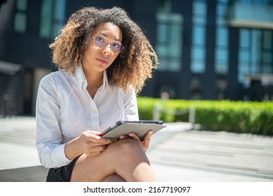 Black Business Woman Using Her Digital Tablet Outdoor In A Business Environment