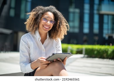 Black Business Woman Using Her Digital Tablet Outdoor In A Business Environment