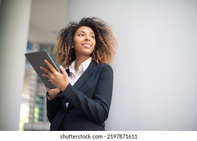 Black Business Woman Using Her Digital Tablet Outdoor In A Business Environment