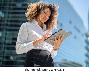 Black Business Woman Using Her Digital Tablet Outdoor In A Business Environment