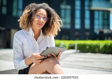 Black Business Woman Using Her Digital Tablet Outdoor In A Business Environment