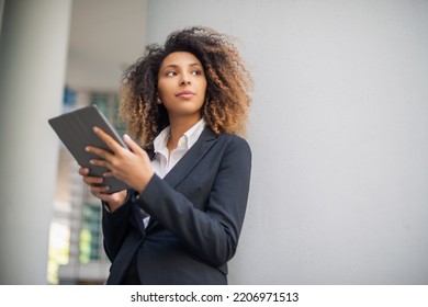 Black Business Woman Using Her Digital Tablet Outdoor In A Business Environment