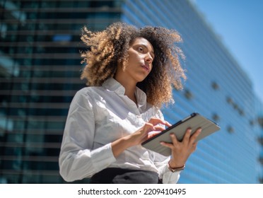 Black Business Woman Using Her Digital Tablet Outdoor In A Business Environment