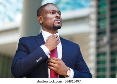 Black businessman adjusting his look