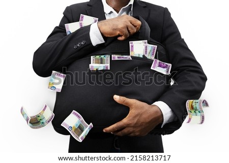 Black Businessman holding black bag full of Central African cfa franc notes isolated on white background, money falling from bag