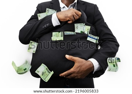 Black Businessman holding black bag full of Libyan dinar notes isolated on white background, money falling from bag Сток-фото © 