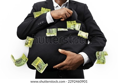 Black Businessman holding black bag full of Yemeni Rial notes isolated on white background, money falling from bag