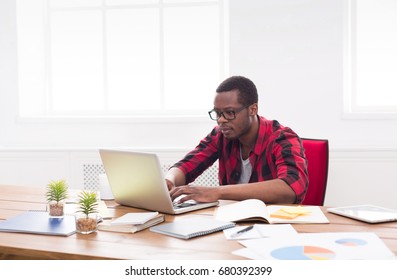 Black businessman in office, in casual, work with laptop - Shutterstock ID 680392399