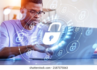 Black Businessman Student Working With Laptop, Security Lock Chain And Glowing Hologram With Digital Icons. Concept Of Privacy And Data Protection