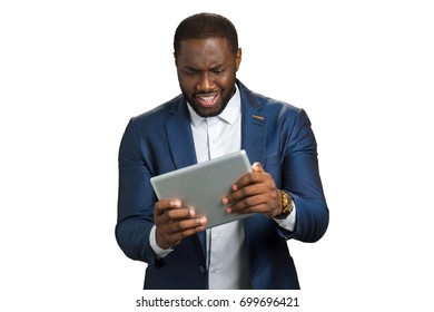 Black Businessman Surprised Looking At Computer Tablet. Afro American Manager Hold Touch Screen Tablet And Smile With Amazement.