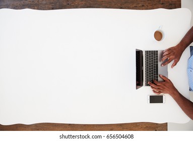 Black Businessman Using Laptop At A Desk, Overhead Shot