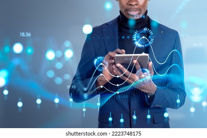 Black businessman using tablet, virtual screen with forex digital diagrams and candlesticks. Big business data analysis and metaverse. Concept of trading - Powered by Shutterstock