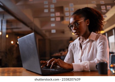 Black businesswoman working on laptop. Portrait of beautiful businesswoman in the office. 