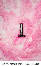 Black Butt Plug Toy On Pink Feathers