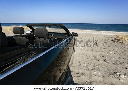 black cabriolet on beach and hot summer day 