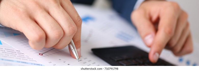 Black Calculator And Financial Statistics On Infographics At Office Table Closeup. Internal Revenue Service Inspector Sum Check, Irs Investigation, Earnings, Savings, Loan And Credit Concept