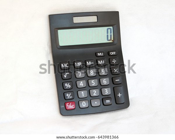 Black\
calculator on white background, Top view. It is something used for\
making mathematical calculations, in particular a small electronic\
device with a keyboard and a visual\
display.