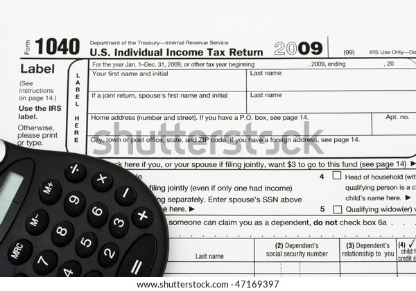 A black\
calculator sitting on tax papers, tax\
forms
