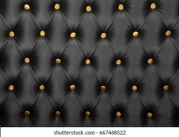 Black capitone textile background with golden yellow buttons, retro Chesterfield style soft tufted fabric furniture upholstery diamond pattern decoration, close up