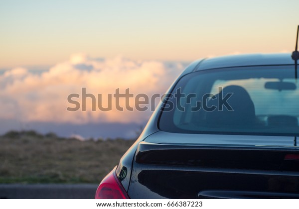 Black car above the\
clouds