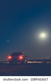 Black Car In The Field At Night