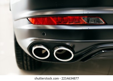 Black Car Headlight Close Up And Exhaust Pipe