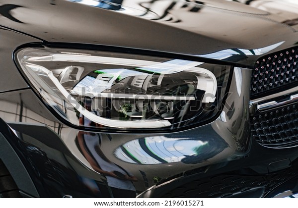 black car headlight. sale of cars.\
dealership. rent and sale of high-class\
cars.