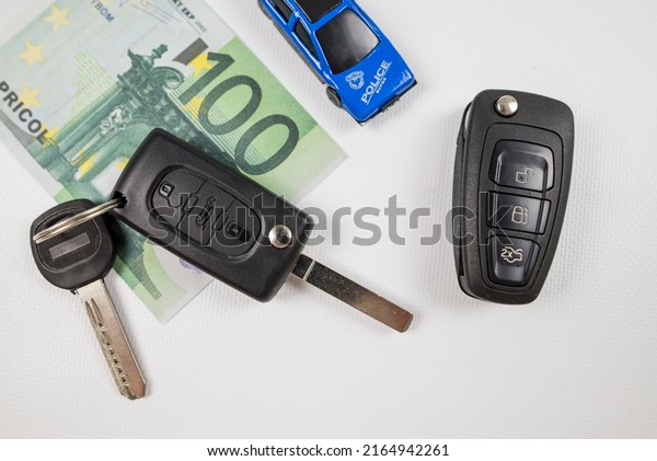 black car key euro money and blue toy car, car\
insurance, sale or rent