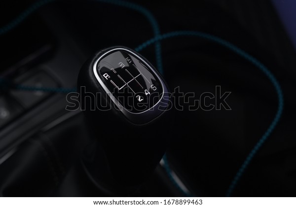 A black car luxury interior with the\
gear level inside the car with the natural\
light