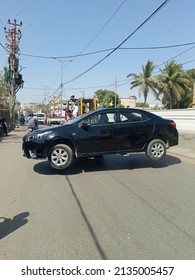 A black car on a lifter being transported on road . - Karachi Pakistan - Mar 2022